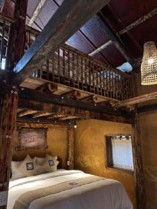 a bedroom with a wooden bunk bed in a room at SUNG Home in Dồng Văn