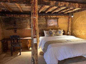 a bedroom with a large bed and a chair at SUNG Home in Dồng Văn