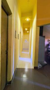 an empty hallway in an office building with yellow walls at Jujuy Hub Hostel in Reyes