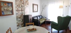 a living room with a couch and a table at Pipo People House in Óbidos