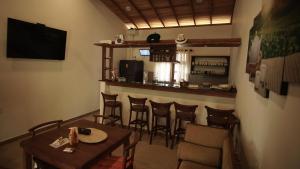 a restaurant with a table and chairs and a bar at Neos Palm Paradise in Aluthgama