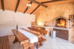una camera da letto con camino, tavolo e panche di Villa Brigita, a beautiful villa close to the beach a VeliGolji