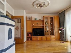 a living room with a flat screen tv on a wooden floor at Ferienhaus Bergblick in Sellrain