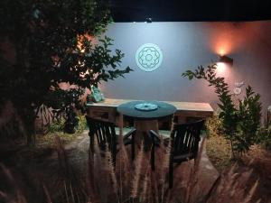 a wooden table in a garden at night at Departamento Perico Jujuy in Perico