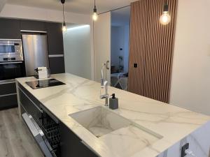 a kitchen with a sink and a counter top at Alicante City Suite 2 in Alicante +30 photos