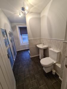 a bathroom with a toilet and a sink at Our Salad Days Lochgilphead in Lochgilphead +16 photos