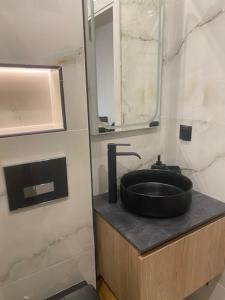 a bathroom with a black sink and a mirror at Real City Nikis in Athens