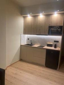 a kitchen with a sink and a counter top at Real City Nikis in Athens +2 photos