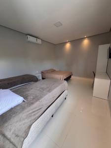 a bedroom with two beds in a room at Casa Alter do Sol - 3 suites in Alter do Chao +9 photos