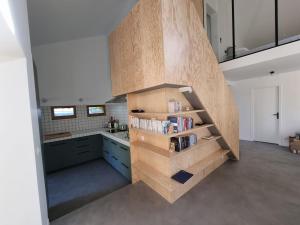 a kitchen with a spiral staircase in the middle at Designer House with Breathtaking View in Orry-la-Ville