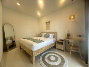 a bedroom with a bed and a desk and a bed sidx sidx sidx at Stylish Villa, 2BR ,GREAT VALUE, Great Location ! in Uluwatu +42 photos