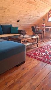 a living room with a couch and a table at Brvnara Topilo in Niš