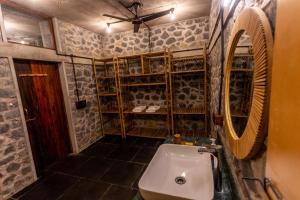 a bathroom with a sink and a mirror at Dang Forest Retreat in Bāori