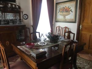 a dining room with a wooden table and chairs at Villa Andrade in Mor +7 photos