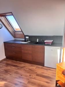 a kitchen with a sink and a counter with a window at Kwatery u Szymka in Jastarnia +62 photos