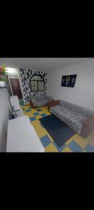 a room with two beds and a floor with checkered floors at Olimp SeaSun in Olimp