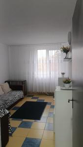 a room with a bed and a tiled floor at Olimp SeaSun in Olimp