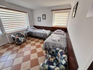 a bedroom with two beds and a couch in it at Kwatery u Szymka in Jastarnia