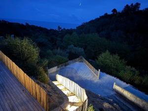 a swimming pool on a deck with a wooden fence at Appartement Mare è Machja vue mer in Sari Solenzara