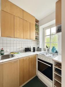 a kitchen with a sink and a stove top oven at Bella Nella, dein feinzeit Apartment in Bamberg