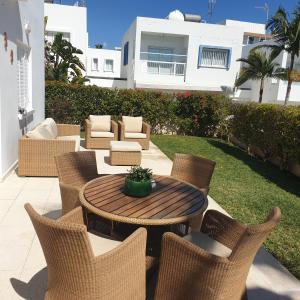 a patio with a table and chairs and a building at SWeET LEMON VILLA in Protaras