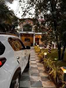 a car parked in front of a house at SEAs THE DAY LUXURIOUS 5BHK VILLA 2min From Awas Beach With Huge Private Pool in Alibaug