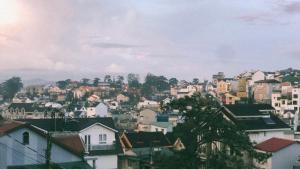 a view of a city with houses and buildings at Vườn Lan Homestay Nguyên Căn SĐT 0337-037-654 in Da Lat +15 photos
