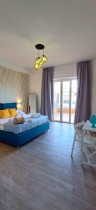 a large bedroom with a blue bed and a table at G&A rooms in Sorrento +28 photos