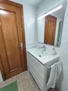 a bathroom with a sink and a mirror at Relax on Miramar Beach in Miramar