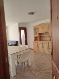a kitchen with a table and chairs in a room at Relax on Miramar Beach in Miramar +17 photos