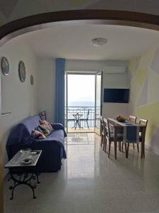 a living room with a couch and a table at Ambra Holiday House in Furore