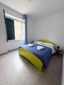 a bedroom with a bed with towels on it at Ambra Holiday House in Furore