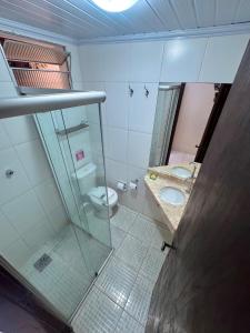 a bathroom with two toilets and a glass door at Yes Hotel Pousada in Abraão +38 photos