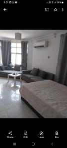 a bedroom with a bed and a couch and a table at Female privat rooms cairo center in Cairo