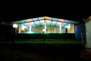 a building lit up at night with lights at The Escapee Resort in Mussoorie