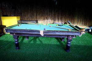 a pool table with balls on top of it at The Escapee Resort in Mussoorie
