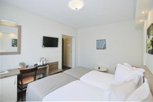 Postel nebo postele na pokoji v ubytování Potaissa Hotel