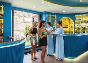 a group of women standing around a bar at Halong Collection Of The Sea Cruises in Ha Long