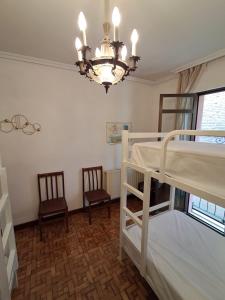 Postel nebo postele na pokoji v ubytování ALBERGUE CASA ARQUEÑA sólo peregrinos con credenciales