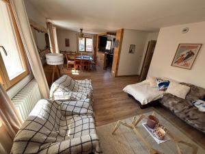 a living room with two couches and a table at le petit sport 2 in La Salle-les-Alpes