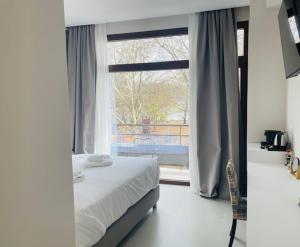A bed or beds in a room at Z Inn Ioannina
