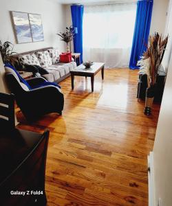 a living room with a couch and a table at Cozy 1 Bedroom Business Suite in Philadelphia