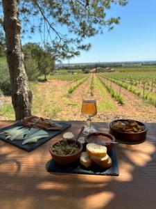 a table with a plate of food and a glass of wine at Camping Le Bois De Pins in Salses-le-Chateau