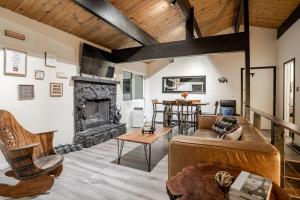 a living room with a couch and a fireplace at Snow Valley Retreat With Spa in Running Springs