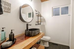 a bathroom with a sink and a mirror at Snow Valley Retreat With Spa in Running Springs +28 photos