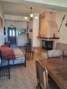 a living room with a couch and a fireplace at TOBY's HOUSE in Poseidónion