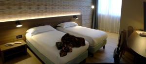 Ένα ή περισσότερα κρεβάτια σε δωμάτιο στο Hotel Ambra