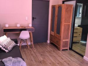a bedroom with a desk and a dresser and a bed at Modern, Comfy Guest Suite with Beautiful Views in Tygerberg Hills