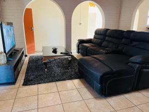 a living room with a couch and a tv at Changill Self Catering CC in Walvis Bay