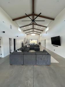 a large living room with a large couch and a flat screen tv at Yuba Lake Barndominium Resort in Levan
